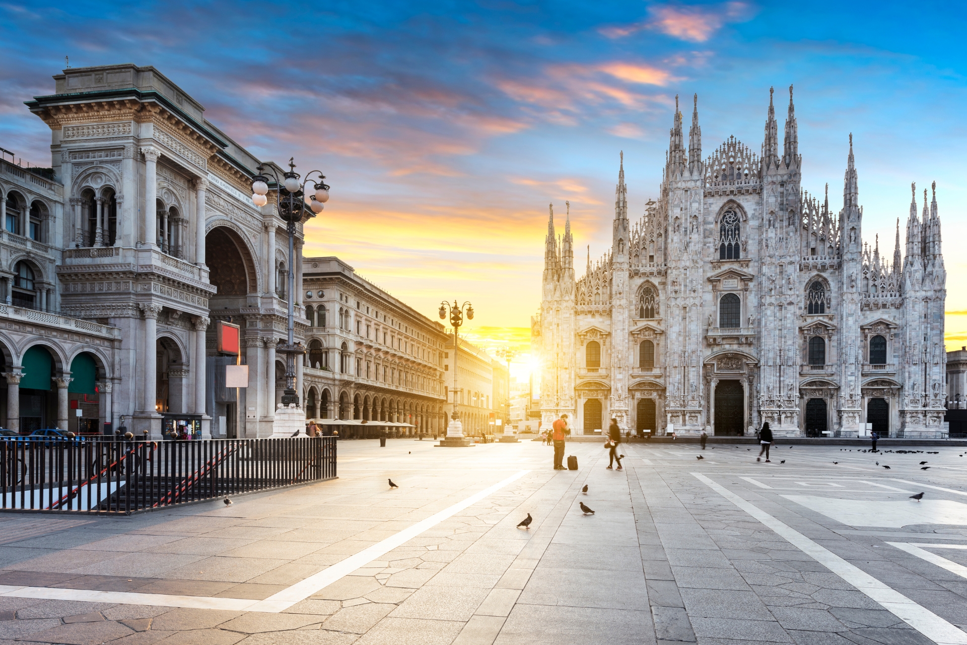 Elegant couple walking through Galleria Vittorio Emanuele II in Milan, dressed for the opera, with luxury boutiques and warm evening lights